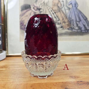 Side view of fairy lamp A showing the red glass shade in the clear pressed glass base