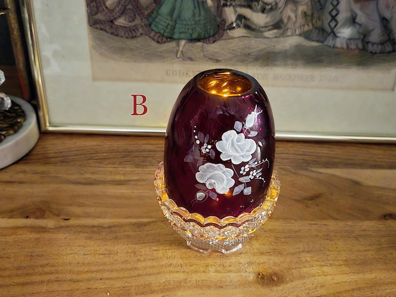 Fairy lamp labeled B lit from inside with warm yellow light
