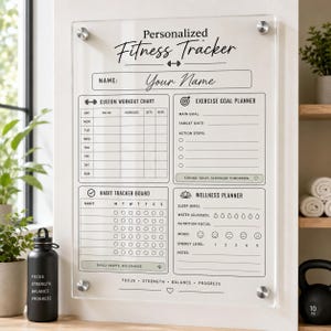 May include: A clear acrylic wall-mounted fitness tracker board featuring black printed text and grids. Sections include a custom workout chart, exercise goal planner, habit tracker board, and wellness planner with fields for sleep, water, and mood.