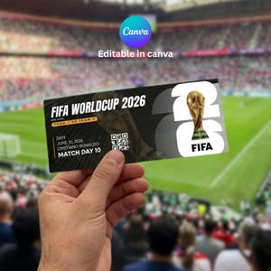 May include: A black and white FIFA World Cup 2026 ticket held in a hand. The ticket features the text "FIFA WORLD CUP 2026", a QR code, and the date June 10, 2026. The background shows a stadium with spectators.