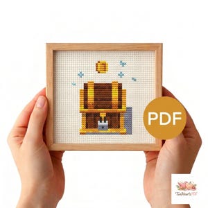 May include: A cross-stitch design of a treasure chest with a gold coin and blue star accents, set in a wooden frame. The image includes the text "PDF" and the logo "Two Hearts PDF".