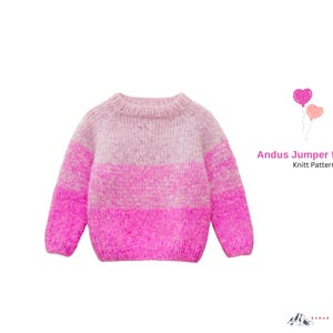 May include: A pink and light pink knitted sweater with a crew neck and long sleeves. The sweater has a color block design with a gradient effect. Text on the right says "Andus Jumper for Girls Knitt Pattern".