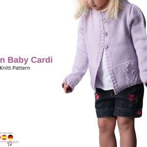 May include: A light purple knitted baby cardigan with three buttons and a floral design on the pocket. The text "Ceylan Baby Cardi Knitt Pattern" is displayed on the left side of the image.