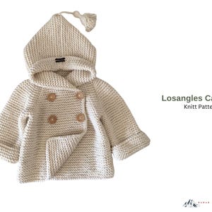 May include: A cream-colored knit cardigan with a hood and wooden buttons. The hooded jacket has a double-breasted design and a tassel on the hood. The text "Losangles Cardigan Knitt Pattern" is visible on the right side.