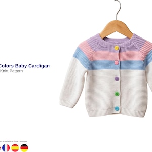 May include: A baby cardigan in white, light blue, pink, and lavender stripes, with matching buttons. The long-sleeved knitwear is displayed on a wooden hanger against a white background. The text "Armani Colors Baby Cardigan" is visible.