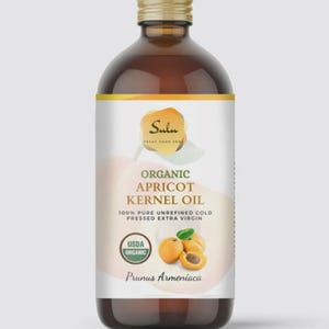 May include: A brown glass bottle of Sulu Organic Apricot Kernel Oil. The label features the text "Organic Apricot Kernel Oil" and "100% Pure Unrefined Cold Pressed Extra Virgin". The label also includes a USDA Organic seal and an illustration of apricots.