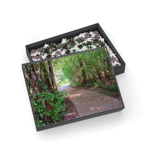 May include: A set of three ceramic mugs with a speckled, matte finish in cream, light brown, and dark brown. Each mug has a simple, minimalist design, ideal for tea or coffee.