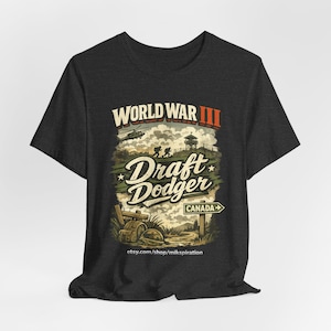 May include: Dark gray t-shirt with a graphic design. The design features the text "World War III" above "Draft Dodger" with a sign pointing to Canada. A helicopter, soldiers, and a watchtower are also depicted.