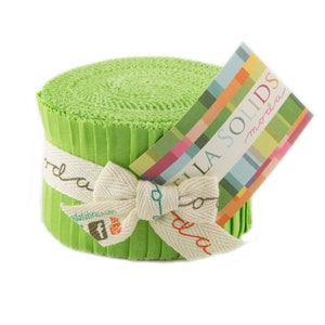 May include: A roll of green Moda Bella Solids fabric, tied with a white ribbon and a tag that reads "Moda Bella Solids".