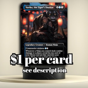 May include: A Magic: The Gathering card featuring "Yuriko, the Tiger's Shadow." The card depicts a ninja with a tiger in a nighttime setting with red lanterns. The card is displayed on a black stand.