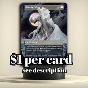 May include: A Magic: The Gathering card titled "Ghostly Prison" featuring a detailed illustration of a ghostly figure with a moon in the background. The card is displayed on a black stand with the text "$1 per card see description".