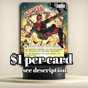 May include: A white ceramic mug with a black handle and the text "But First, Coffee" in a bold, black font. The mug is set against a blurred background, suggesting a cozy setting.