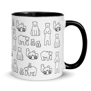 May include: White ceramic mug with a black interior and handle. The mug is covered in a repeating pattern of black and white line drawings of polar bears in various poses. The bears are standing, sitting, and lying down.
