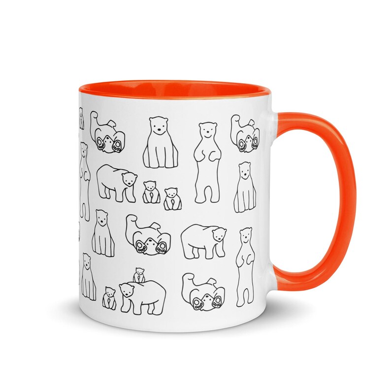 May include: White ceramic mug with an orange interior and handle. The mug is decorated with a repeating pattern of black and white polar bear illustrations in various poses. The mug is suitable for hot or cold beverages.