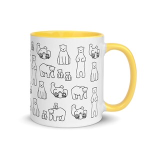 May include: White ceramic mug with a yellow interior and handle. The exterior features a repeating pattern of black line-drawn polar bears in various poses. A fun and whimsical design for a coffee or tea cup.