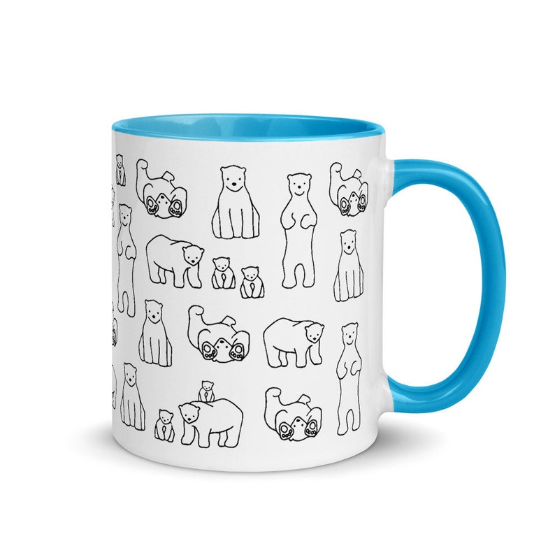May include: White ceramic mug with a blue interior and handle. The mug is decorated with a repeating pattern of black and white cartoon polar bears in various poses. A fun and whimsical design for a coffee or tea cup.