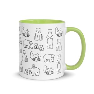 May include: White ceramic mug with a green interior and handle. The mug is decorated with a repeating pattern of black line-drawn polar bears in various poses. The bears are standing, sitting, and lying down. A fun and whimsical design.