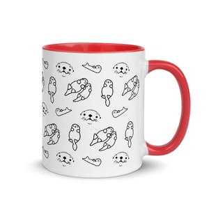 May include: White ceramic mug with a red interior and handle. The mug features a repeating pattern of black line drawings of otters in various poses. The otters are in different positions, some are swimming, some are cuddling, and some are just their faces.