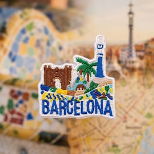 May include: An embroidered patch featuring a stylized depiction of Barcelona landmarks, including a brown stone archway, a blue and white tower, and a green palm tree. The word BARCELONA is stitched in bold blue letters at the bottom.