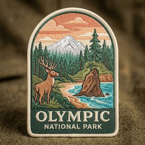 May include: An embroidered patch featuring a landscape of Olympic National Park. The design shows a brown deer, a snow-capped mountain, evergreen trees, and a blue shoreline. The text OLYMPIC NATIONAL PARK is stitched in white at the bottom.