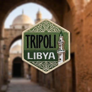 May include: A hexagonal embroidered patch featuring a green background with a white border. The text TRIPOLI is in black and LIBYA is in white. An illustration of a minaret is on the right side, and intricate white geometric patterns decorate the top and bottom.