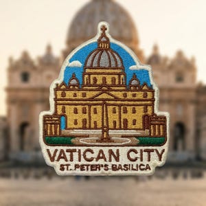 May include: An embroidered patch featuring a depiction of St. Peter's Basilica in Vatican City. The design includes a golden building with a grey dome against a blue sky, with the text "VATICAN CITY" and "ST. PETER'S BASILICA" in brown.