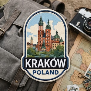 May include: An embroidered patch featuring a detailed depiction of St. Mary's Basilica in Krakow, Poland. The design includes red brick towers, green domes, and lush green trees against a light blue sky. The text KRAKÓW POLAND is printed in white.