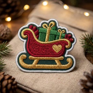 May include: An embroidered patch featuring a red sleigh with gold runners and a gold heart detail. The sleigh is filled with green gift boxes tied with gold ribbons and red berries. The entire design is outlined in white on a dark green background.