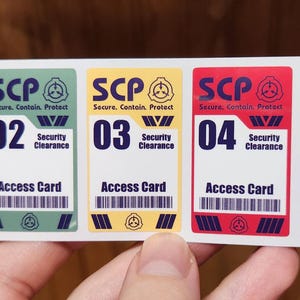 May include: A set of five rectangular SCP access card stickers. Each card features a different color: blue, green, yellow, red, and purple. Each card has the SCP logo, a number, and the words "Security Clearance" and "Access Card".