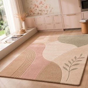 May include: A rectangular area rug featuring a soft, multi-colored abstract pattern with curved shapes in shades of beige, dusty pink, and sage green. The design includes a textured arch motif on one side and a delicate leaf branch illustration.