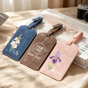 May include: Three rectangular luggage tags with adjustable straps. The blue tag features a floral print and the name Lily. The brown tag displays the text YOUR LOGO and YOUR TEXT. The pink tag shows a purple iris flower and the name Kora.