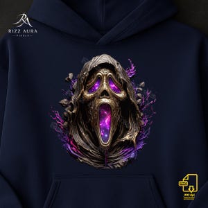 May include: Navy blue hoodie featuring a detailed graphic of a Scream mask with a cosmic galaxy design in the eyes and mouth. The mask is metallic gold and bronze, surrounded by purple energy and stone fragments. The hoodie has a front pocket and a hood.