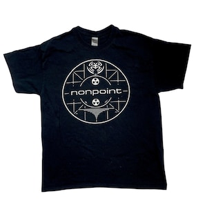 May include: Black t-shirt featuring a white graphic design. The design includes a circular pattern with the word "nonpoint" in the center. The graphic also includes various symbols and lines, creating a unique visual.