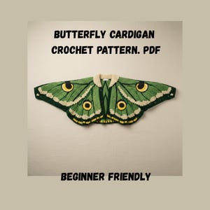 May include: A green and cream-colored crochet butterfly cardigan. The cardigan has a button-up front and is designed to resemble a butterfly. The text "BUTTERFLY CARDIGAN CROCHET PATTERN. PDF" and "BEGINNER FRIENDLY" are displayed.
