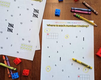 Puede incluir: Dos hojas de trabajo educativas tituladas Where is each number 10 hiding? y Where is each number 1 hiding? con números, marcas de conteo y marcos de diez. Alrededor hay cubos de plástico entrelazables de colores y varios lápices de cera.