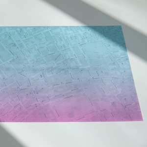 May include: A rectangular print featuring a detailed city street map with a gradient colour scheme that transitions from light blue at the top to a soft purple at the bottom, displaying various street names, blocks, and urban layout details.