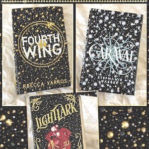 May include: Three custom bedazzled books with black covers. The top book has the text "FOURTH WING" in gold, the middle book has "CARAVAL" in teal, and the bottom book has "LIGHTLARK" in gold. The books are decorated with small, sparkling embellishments.