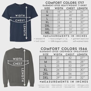 May include: A size chart for Comfort Colors 1717 heavyweight t-shirts and 1566 crewneck sweatshirts. The image displays two garments with arrows indicating width, chest, and length measurements, alongside tables listing dimensions in inches for sizes S to 4XL.