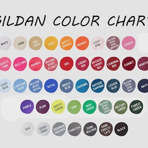 May include: A Gildan color chart featuring rows of circular swatches in various shades including white, sand, gold, orange, pink, red, blue, purple, green, gray, brown, and black. Each circle is labeled with its corresponding color name in text.