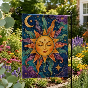 May include: A garden flag featuring a celestial design with a sun, moon, stars, and clouds. The sun has a serene face with closed eyes, surrounded by orange, teal, and purple rays. The background is a dark blue with stars, and the flag is hanging on a black metal stand.
