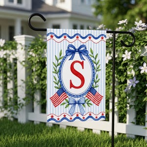 May include: A patriotic garden flag featuring a blue and white striped background. The flag displays a red letter "S" inside a blue oval with a laurel wreath. Two American flags and bows complete the design.