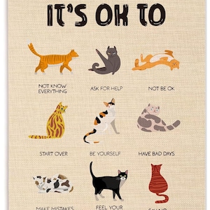 May include: A beige canvas wall hanging with wooden rails featuring nine illustrations of cats in various poses. The text reads IT'S OK TO NOT KNOW EVERYTHING, ASK FOR HELP, NOT BE OK, START OVER, BE YOURSELF, HAVE BAD DAYS, MAKE MISTAKES, FEEL YOUR FEELINGS, SAY NO.