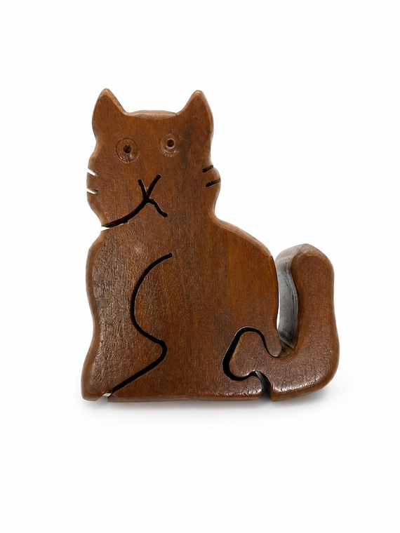 A hand-carved wooden cat that secretly opens into a hidden trinket box — folk art meets puzzle toy, and no one sees it coming.