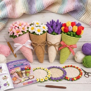 May include: A collection of handmade crochet flower bouquets in various colors, including pink, white, purple, and red. Each bouquet is cone-shaped and tied with a ribbon. A crochet pattern book and coasters are also visible.