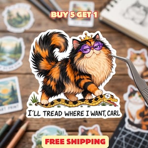 May include: A die-cut sticker featuring a fluffy calico cat wearing a small gold crown and purple round glasses. The cat stands on a yellow and black patterned snake. Below the cat, the text reads, I’LL TREAD WHERE I WANT, CARL.