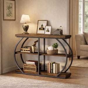 May include: A dark wood and metal console table with three shelves. The table has a curved metal frame and is decorated with books, framed pictures, a lamp, and decorative items. The shelves are filled with books, a basket, and a small potted plant.