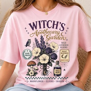 Cottagecore botanical Halloween shirt mockup displaying Retro Witch Herb Garden PNG with vintage floral illustration, spell bottle, mushrooms, moon accents, and autumn-inspired sublimation artwork.