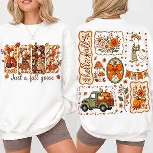 May include: A white sweatshirt featuring a front graphic of four geese in autumn clothing with the text Just a fall goose and a back graphic of a green truck, pumpkins, flowers, mushrooms, and a goose with the text hello fall.