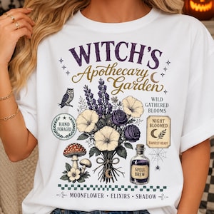 Green witch botanical PNG digital download shown on a premium apparel mockup featuring enchanted garden flowers, vintage apothecary illustration, cottagecore artwork, and fall Halloween fashion.