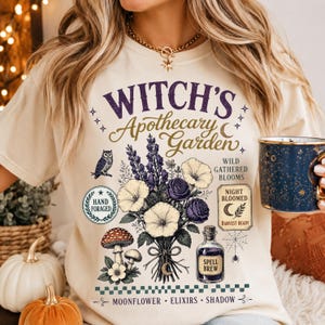 Vintage Witch Apothecary Garden digital download mockup on a natural heavyweight cotton shirt featuring botanical floral bouquet, enchanted garden illustration, retro Halloween design, and witchy aesthetic.